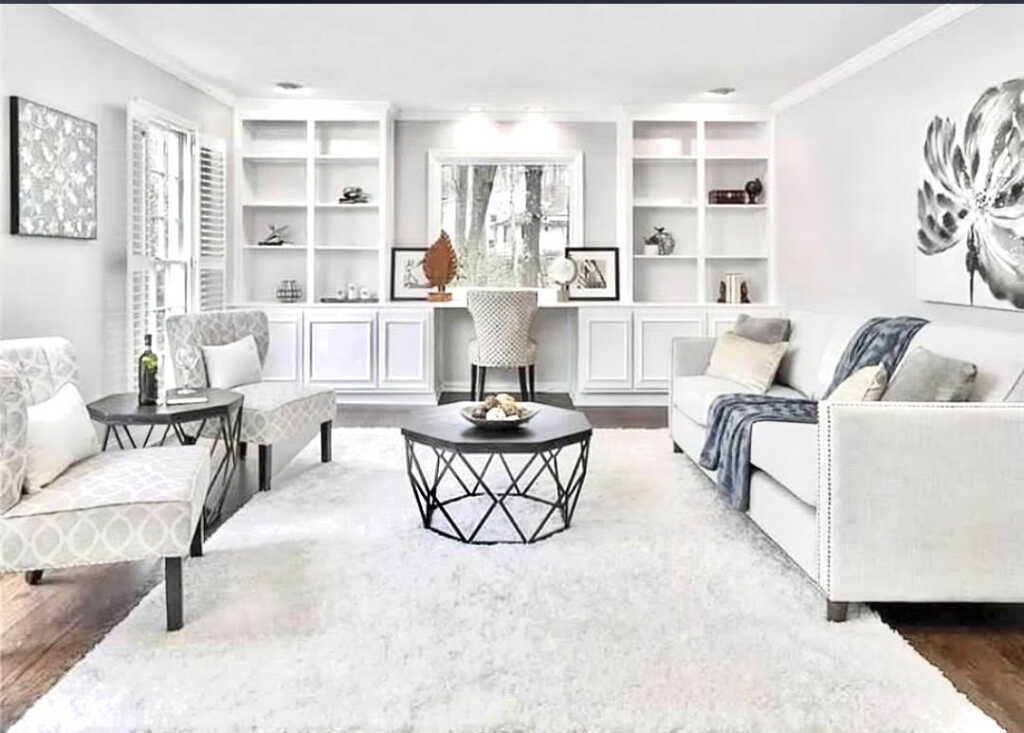 A sitting area in a home with all white furnishings.